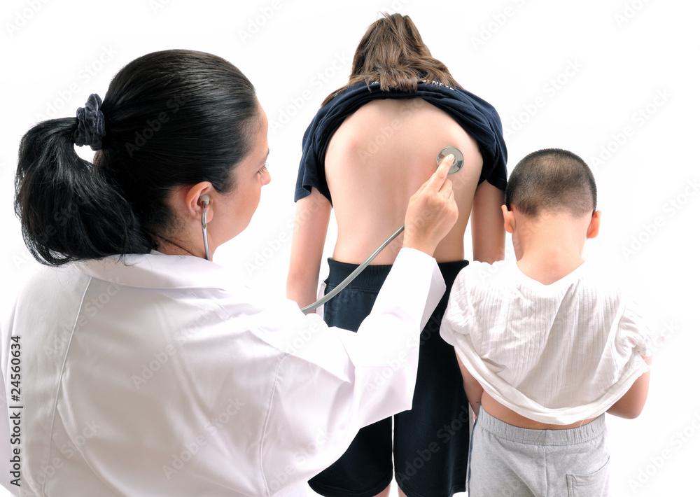 Doctor pediatrician examines teenager, her brother waiting Doctor pediatrician examines teenager, her brother waiting
