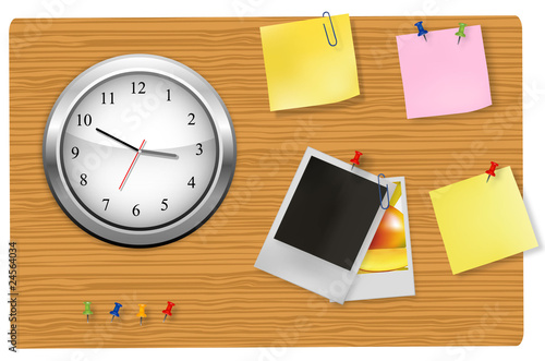A wall office clock and supplies on the board.