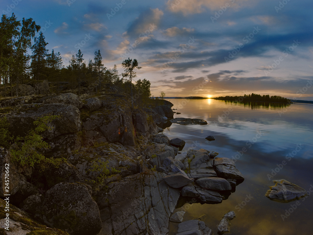 Sunset at stony shore of Ladoga lake