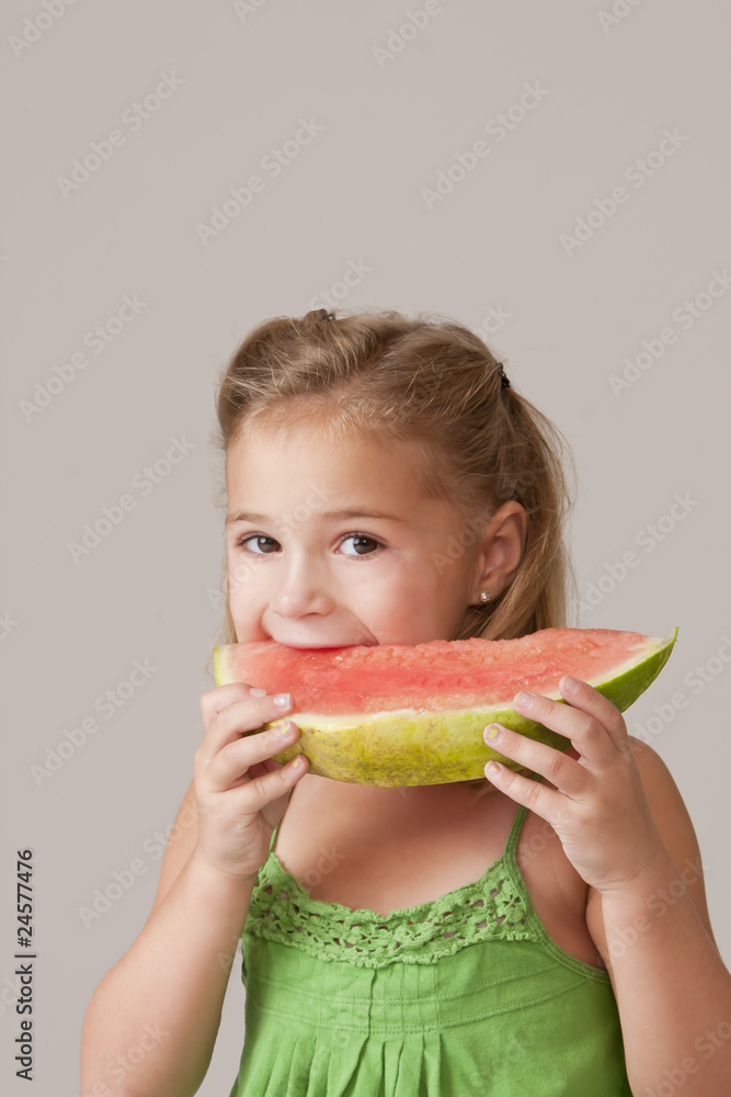 Pretty 5 year old girl eating watermelo Pretty 5 year old girl eating watermelo