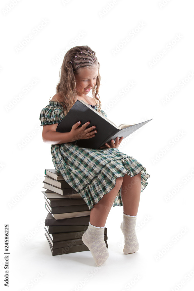 Smiling little girl with pigtails reading a book Smiling little girl with pigtails reading a book