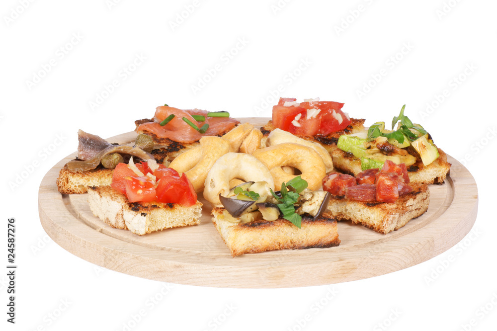 Italian bruschetta and taralli over a wooden cutting board Italian bruschetta and taralli over a wooden cutting board