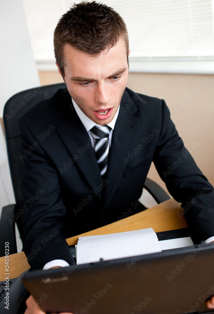 Surprised businessman looking at his laptop Surprised businessman looking at his laptop
