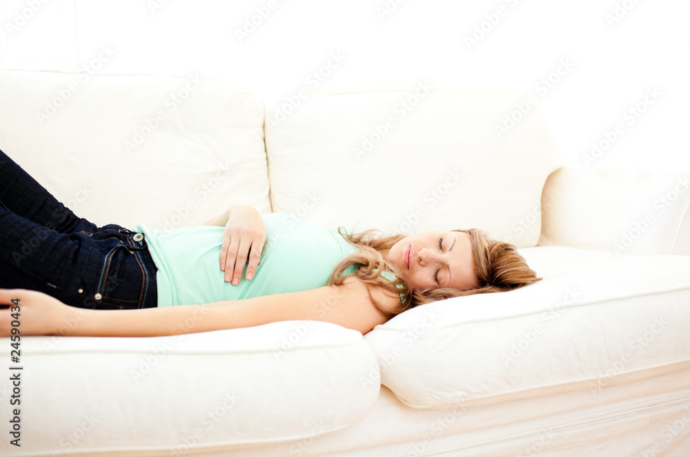 Caucasian blond woman lying on a sofa relaxing Caucasian blond woman lying on a sofa relaxing
