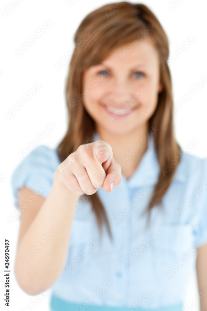 Smiling blond woman showing with a finger at the camera Smiling blond woman showing with a finger at the camera