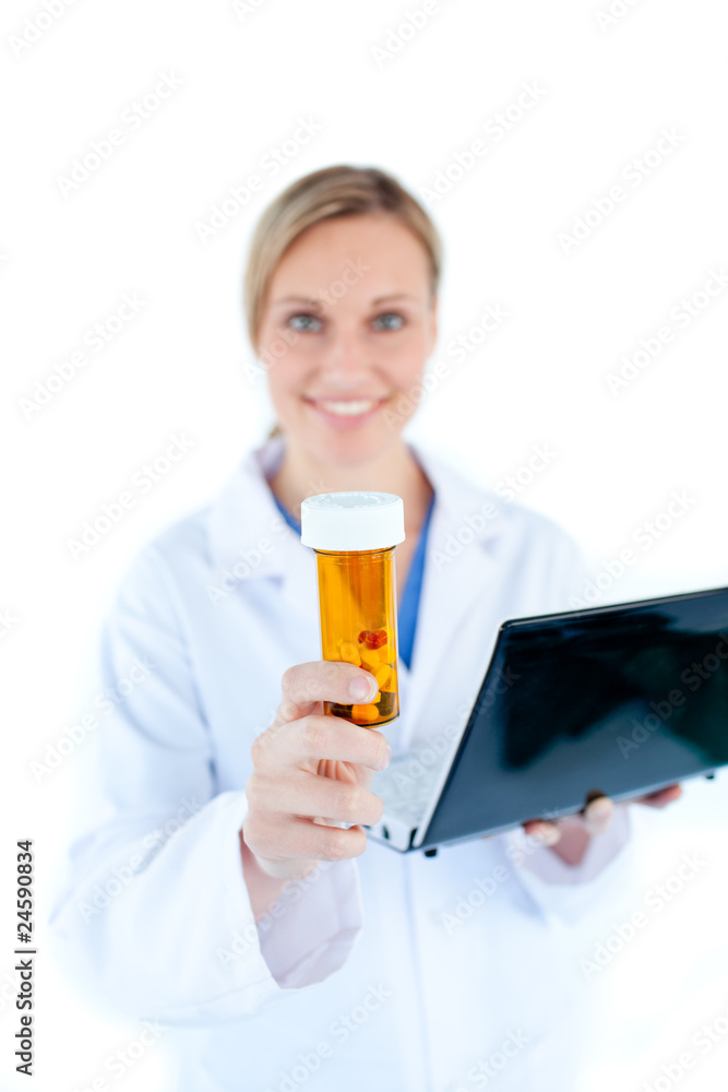 Charesmatic female doctor holding a laptop and pills Charesmatic female doctor holding a laptop and pills