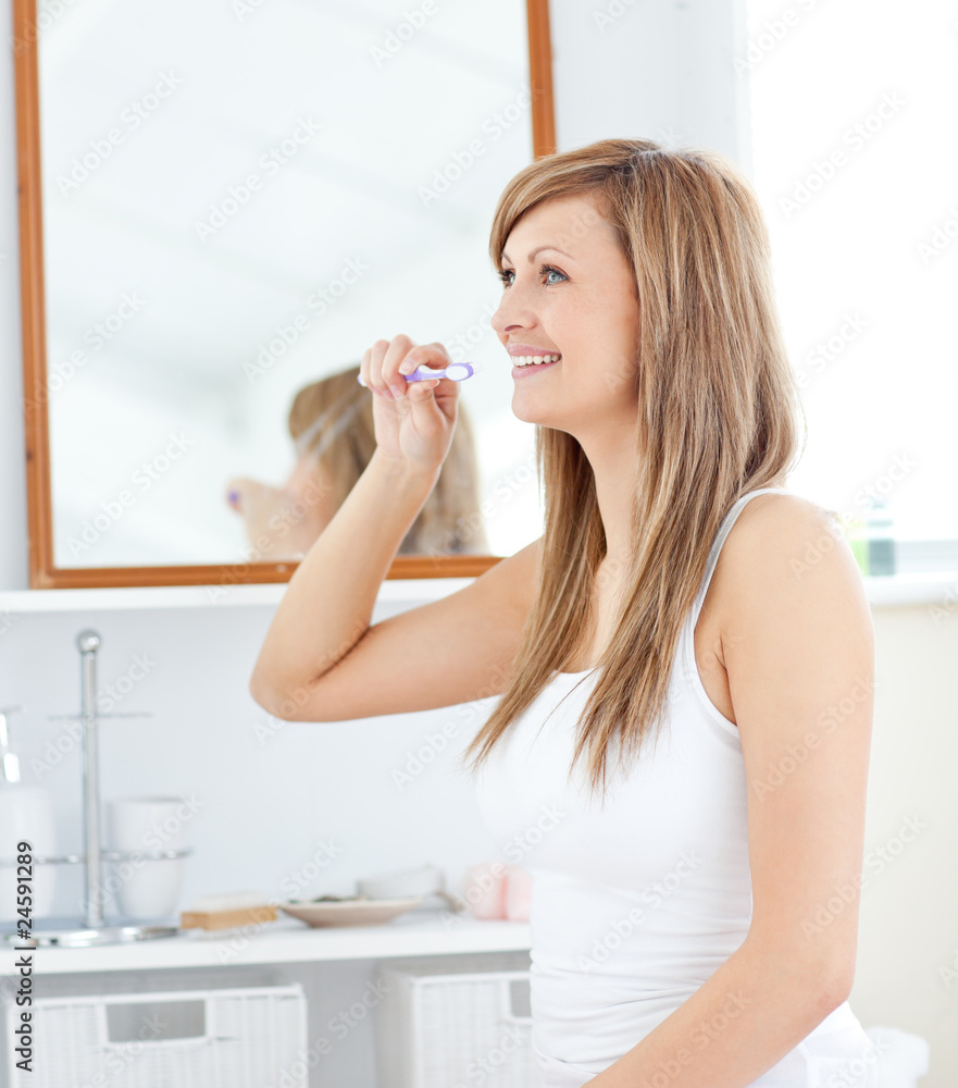 Blond young woman brush her teeth