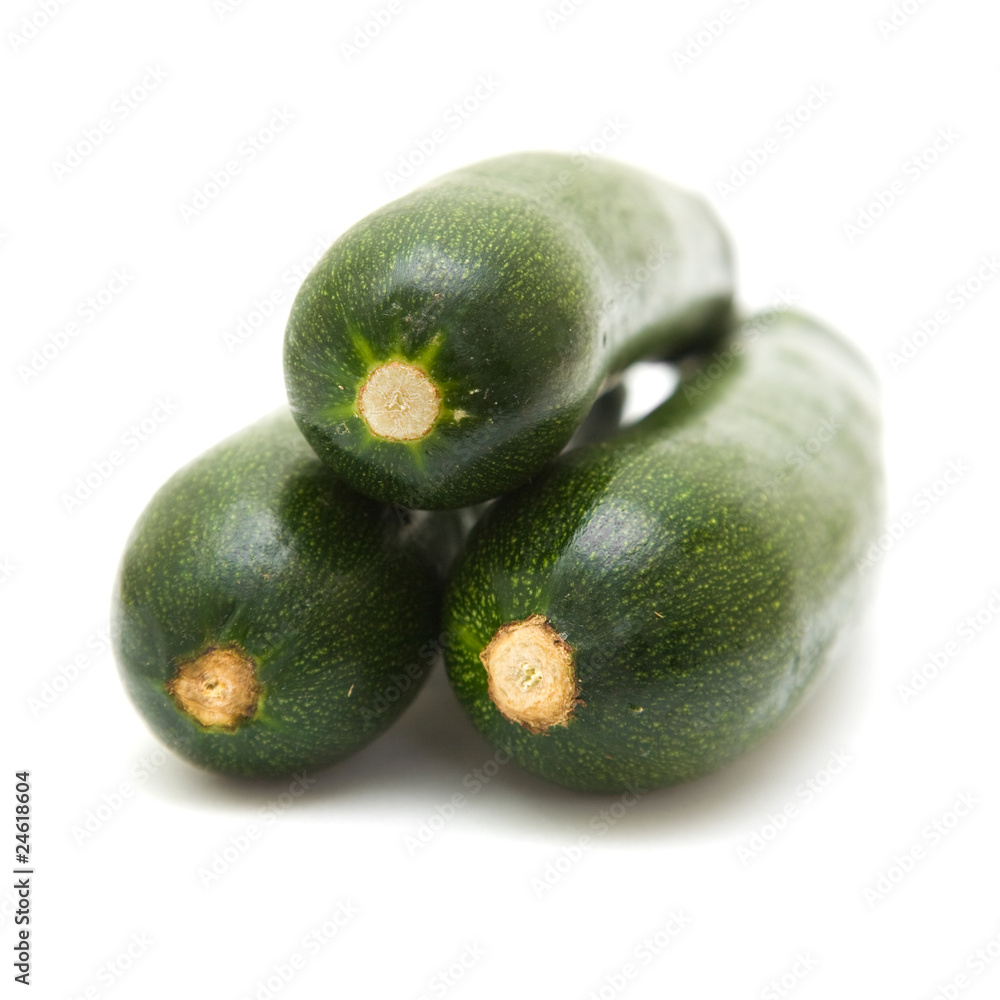 three stacked zucchini ( courgette) isolated on white background three stacked zucchini ( courgette) isolated on white background