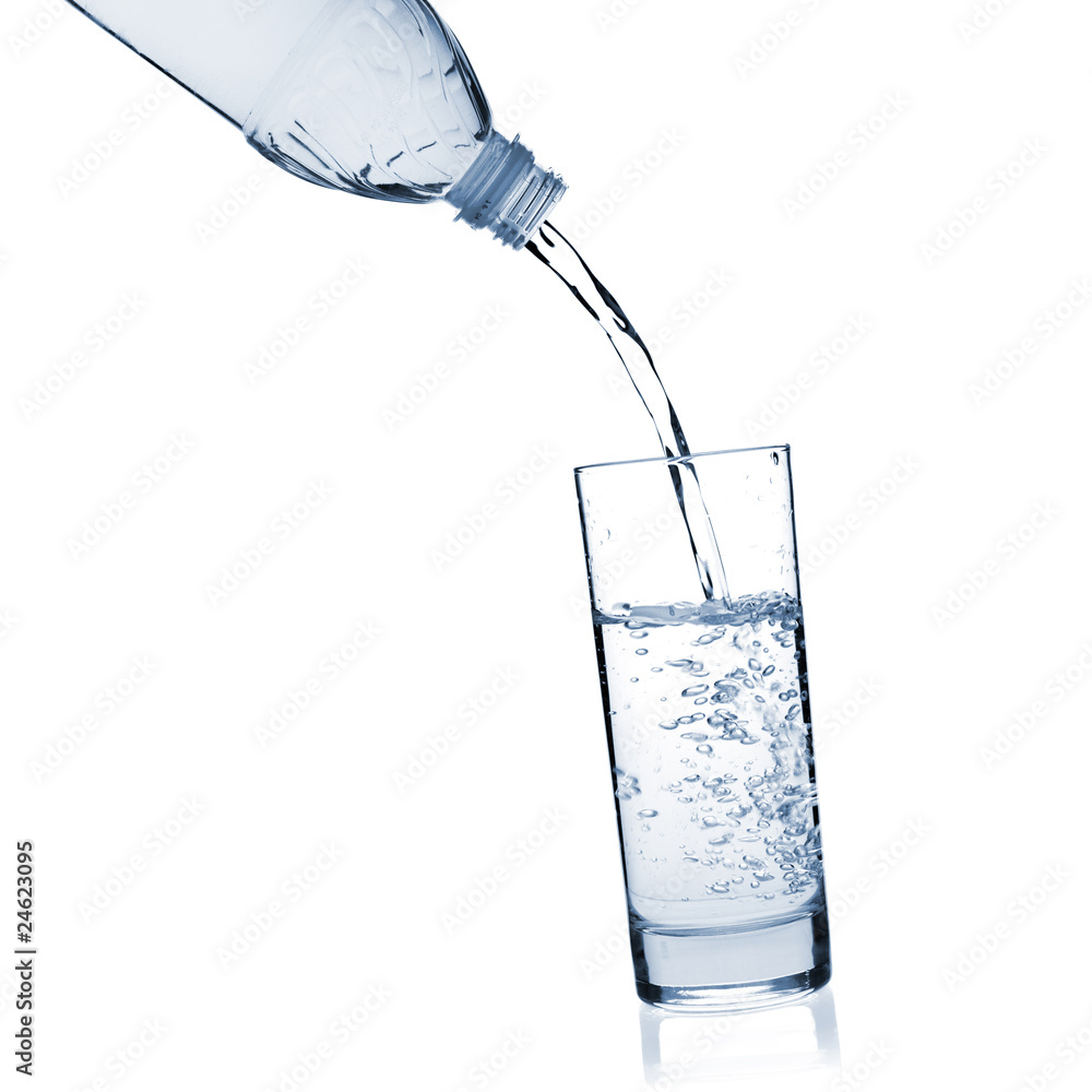 Water is poured into a glass from a bottle Water is poured into a glass from a bottle