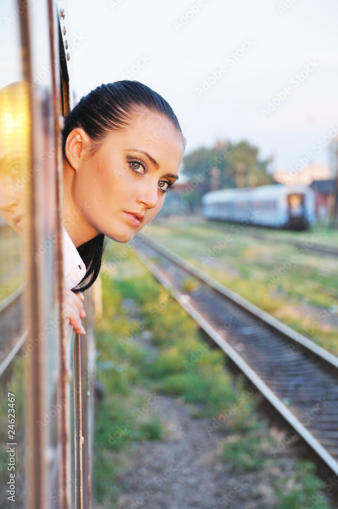 beautiful young lady looking outside the train beautiful young lady looking outside the train