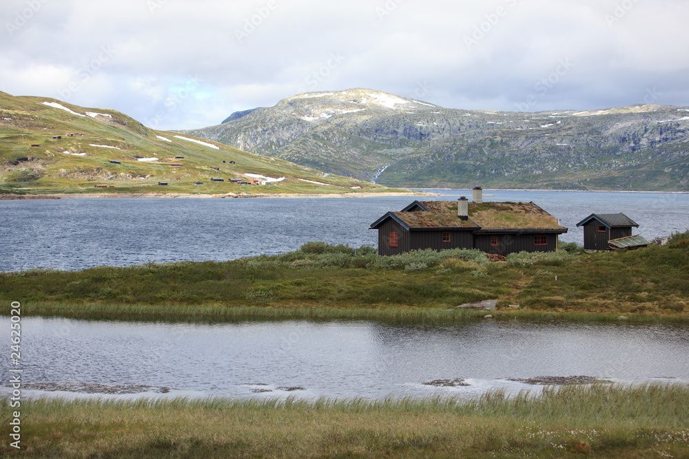 Traditional norwegian house in the rugged landscape.