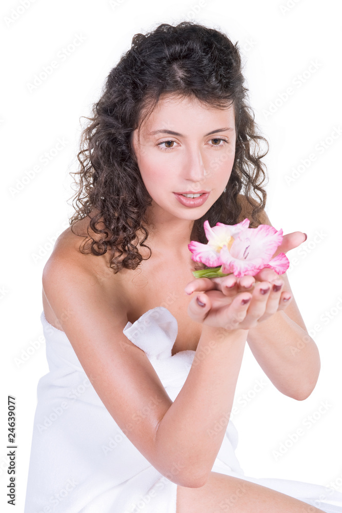 Beautiful woman in tower holding a flower in spa salon Beautiful woman in tower holding a flower in spa salon