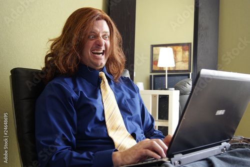 Φωτογραφία Silly Man with Long Hair on Laptop