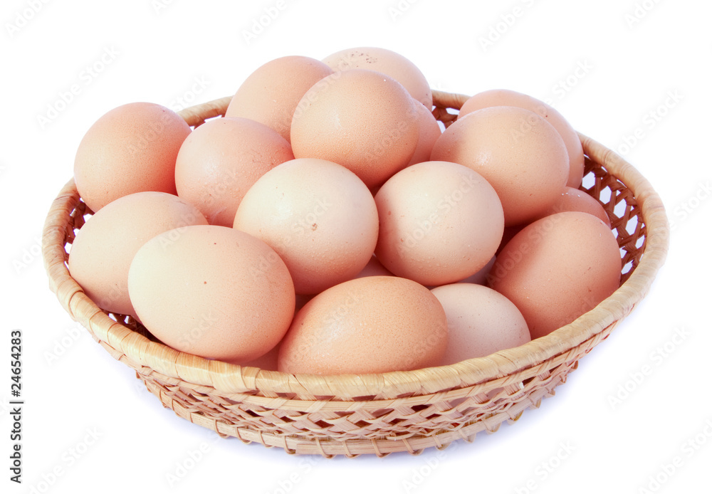 Brown eggs in the basket on white Brown eggs in the basket on white