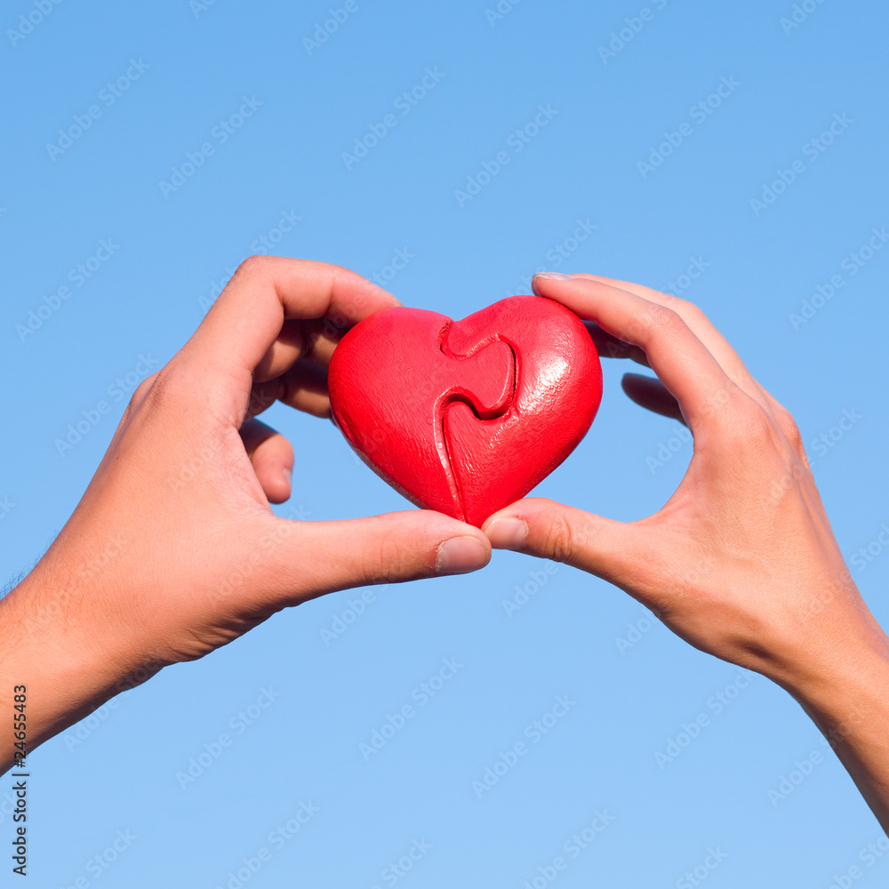 Hands with puzzle heart Hands with puzzle heart