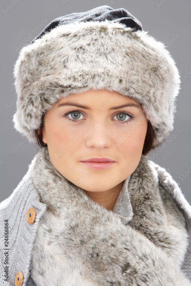 Studio Portrait Of Young Woman Wearing Fur Hat And Wrap Studio Portrait Of Young Woman Wearing Fur Hat And Wrap