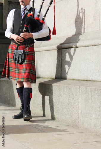 scottish man in kilt playing the bagpipes