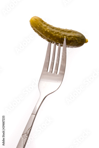 Pickled cucumber on a plug on a white background