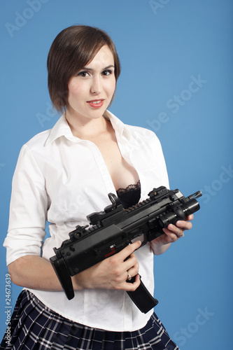 Sexy young woman with an assault gun.