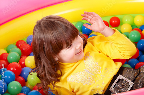 Child playing in group colourful ball.