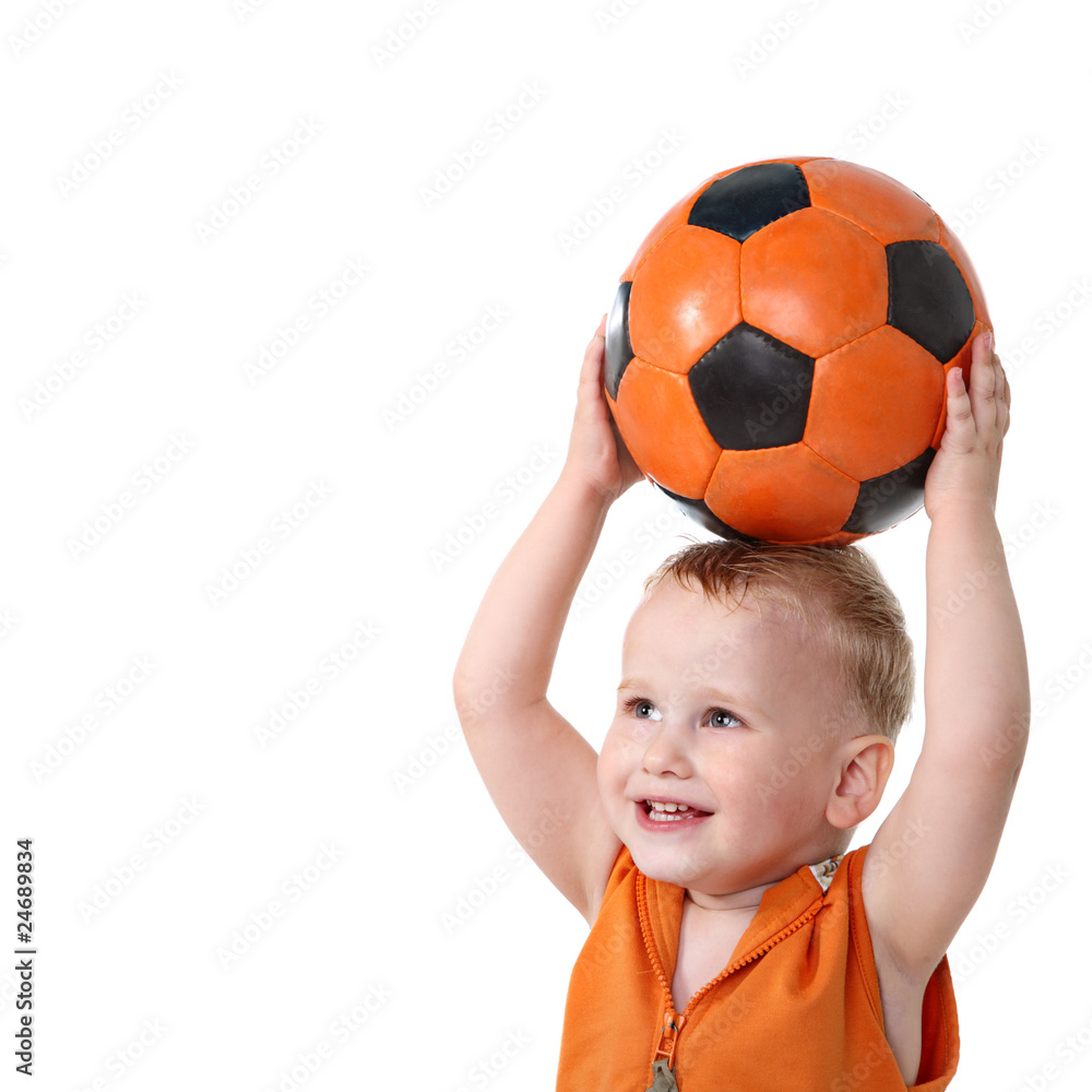 Little boy holding soccer ball