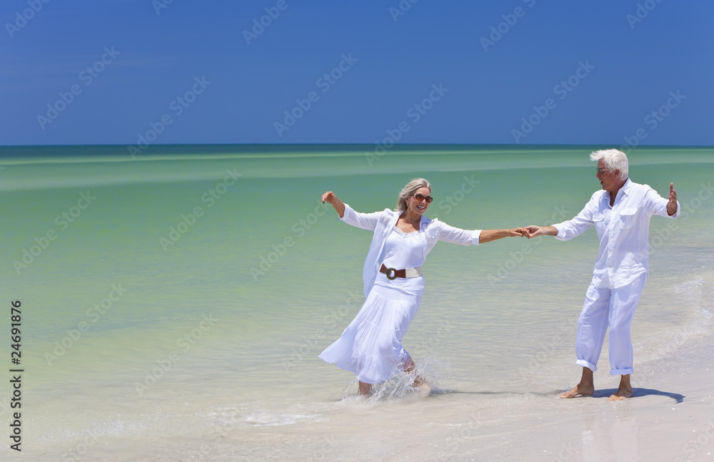 Happy Senior Couple Dancing Holding Hands on A Tropical Beach Happy Senior Couple Dancing Holding Hands on A Tropical Beach