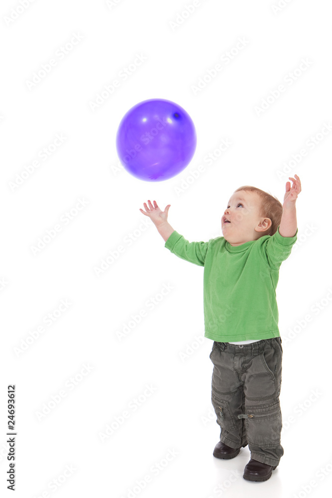 Toddler playing with purple balloon Toddler playing with purple balloon