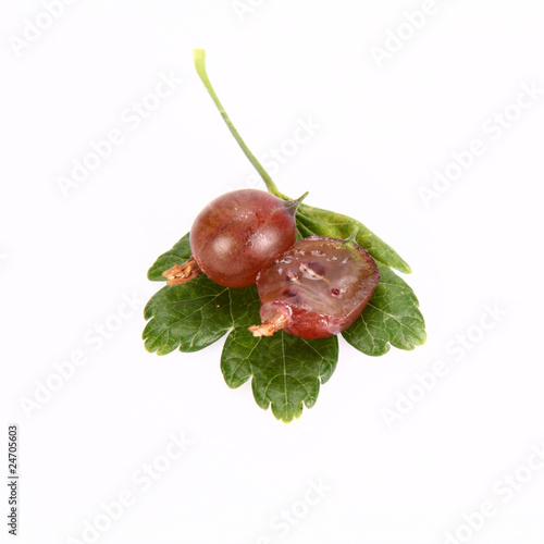 Tableau sur toile Red gooseberries, one cut in half, on a leaf