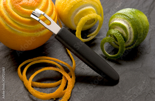 Tablou pe pânză a peeler with slices and an orange, lime and lemon