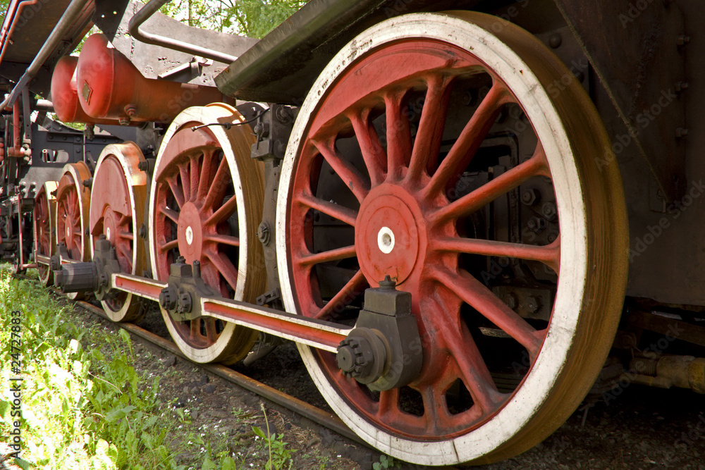 big red rusty wheels of old steam engine