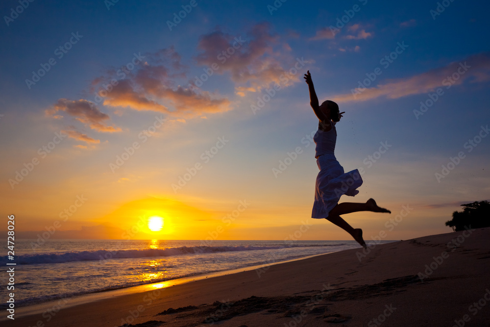 Young girl jumping in the sunset