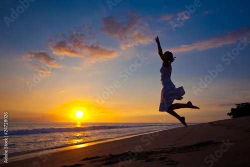 Young girl jumping in the sunset