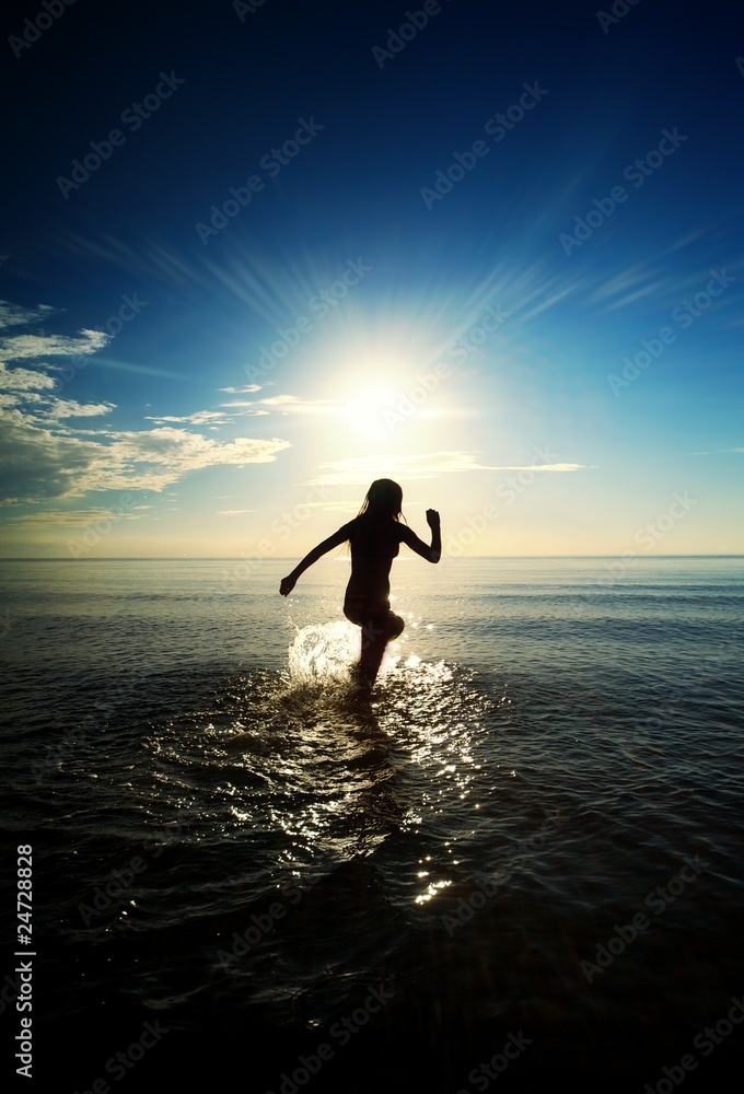 Happy girl running in the sea