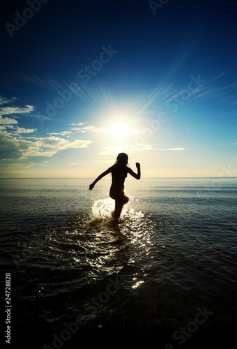 Happy girl running in the sea