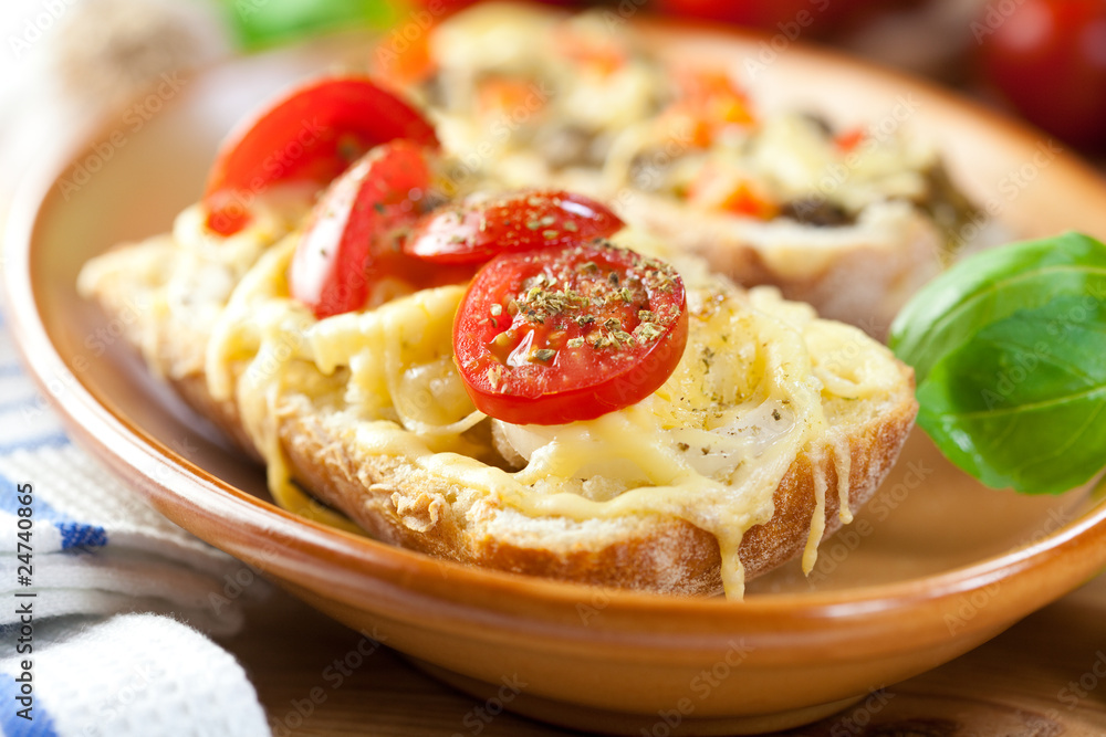 Crostini with cherry tomatoes in a rustic dish Crostini with cherry tomatoes in a rustic dish