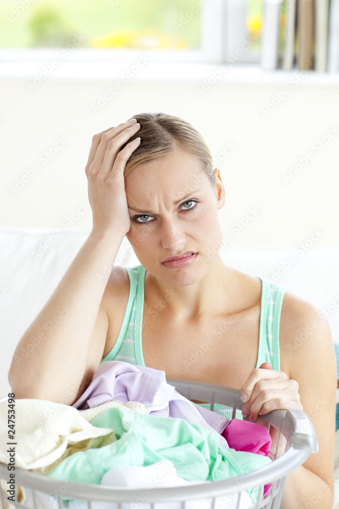 Exhausted young woman doing the laundry