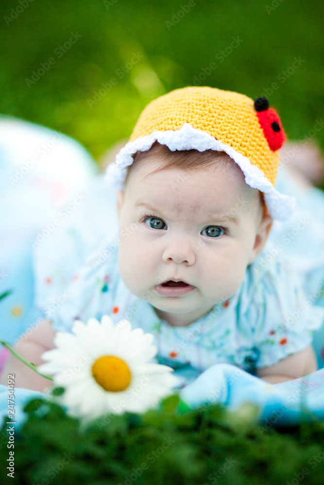 Adorable baby girl outdoors in the grass