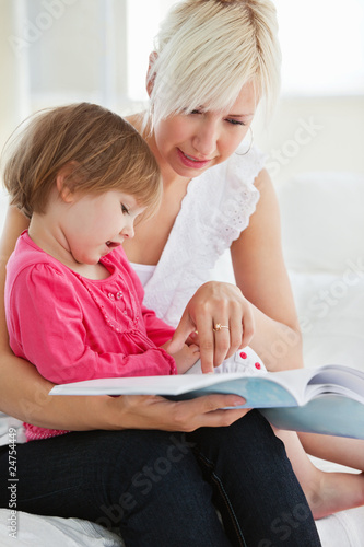 Young family reading a book