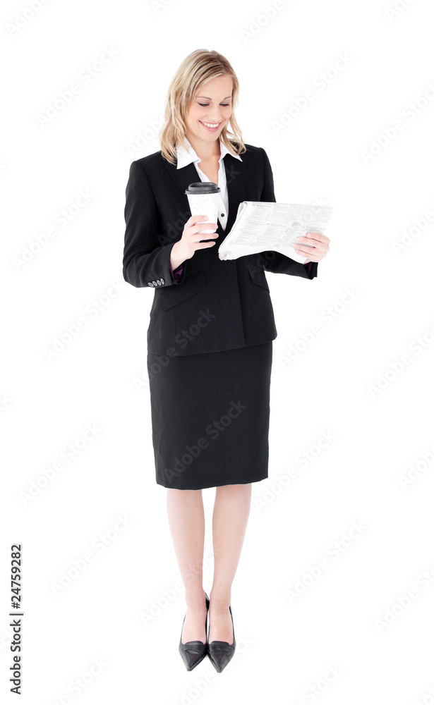 Attractive businesswoman reading a newspaper holding a coffee Attractive businesswoman reading a newspaper holding a coffee