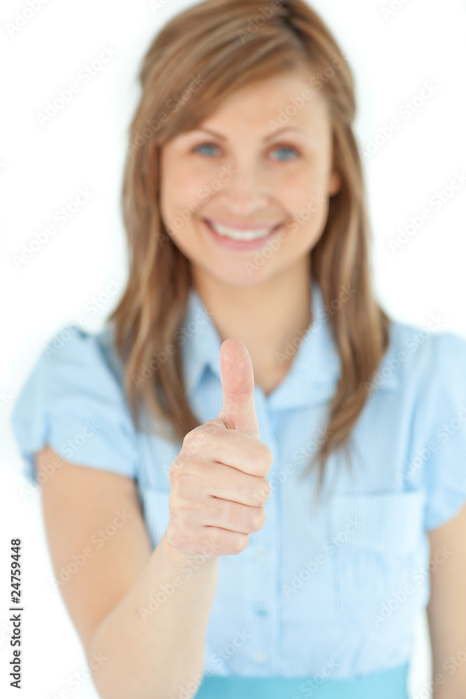 Radiant businesswoman smiling at the camera with thumb up Radiant businesswoman smiling at the camera with thumb up