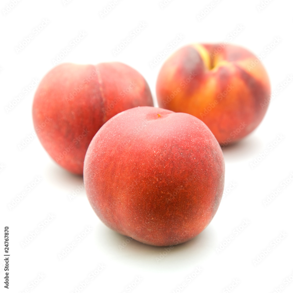 three ripe red peaches isolated on white background