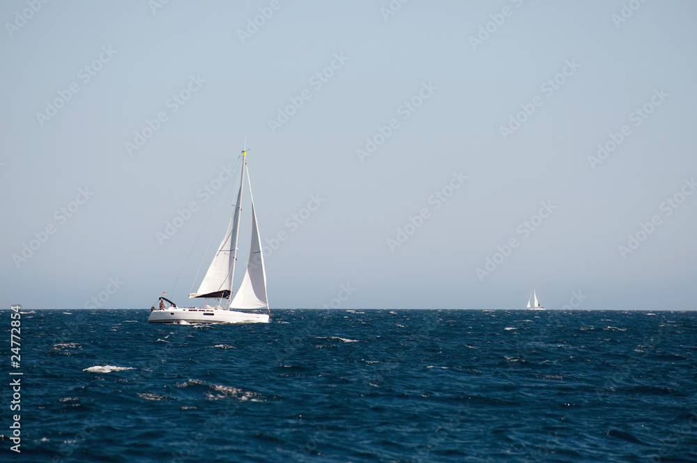 Fototapeta premium yacht sailing on the sea with clear blue sky