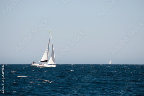 yacht sailing on the sea with clear blue sky