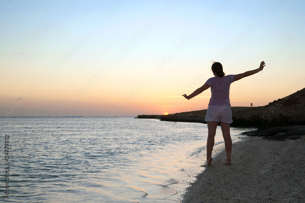 girl at coast sea  during  sunrise