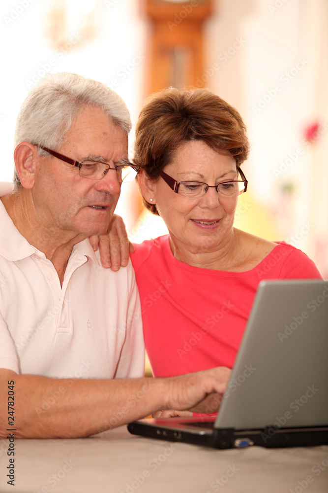 Closeup of senior couple doing online shopping Closeup of senior couple doing online shopping
