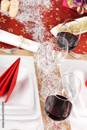 Christmas decorated table, with red wine and plates