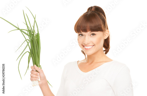 beautiful housewife with spring onions over white