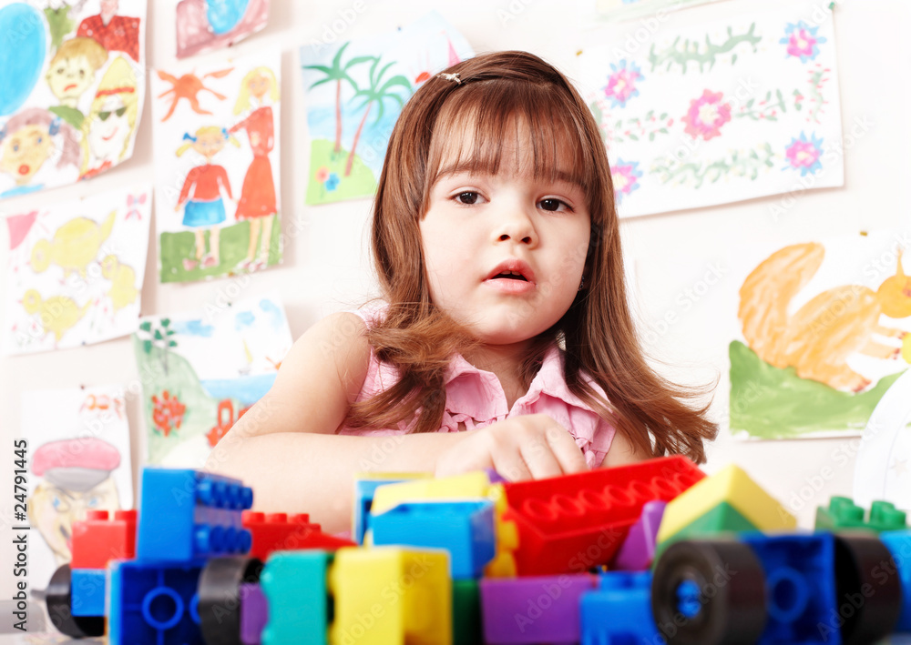 Fototapeta premium Child playing construction set in play room.
