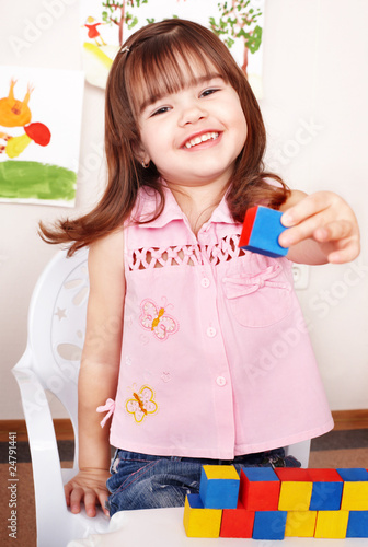 фотографія Child playing  block in play room.