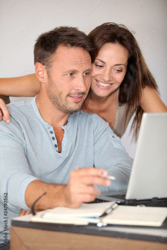 Couple at home surfing on internet Couple at home surfing on internet